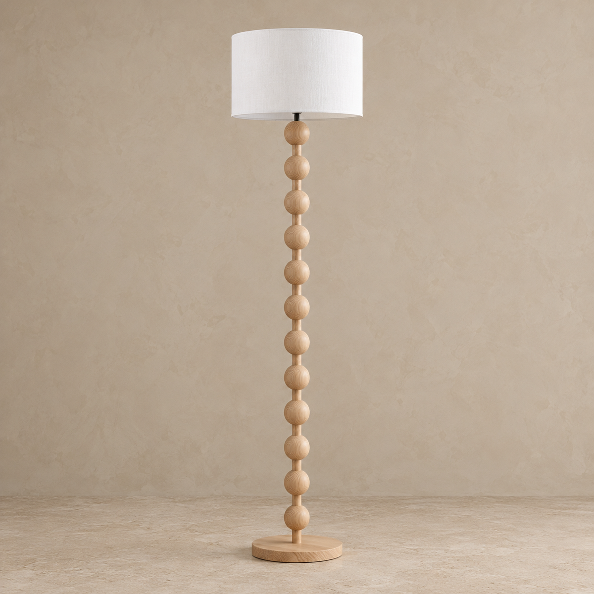 Sirmione floor lamp in natural Log finish, switched off, on a circular wooden base.
