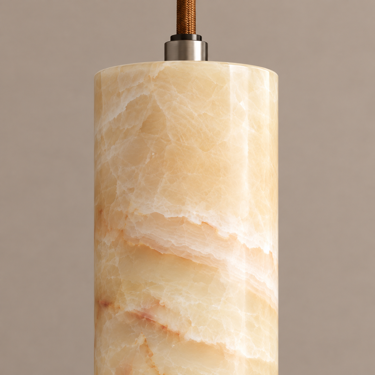 Close-up of the slim honey onyx cylinder and metal cable connector.