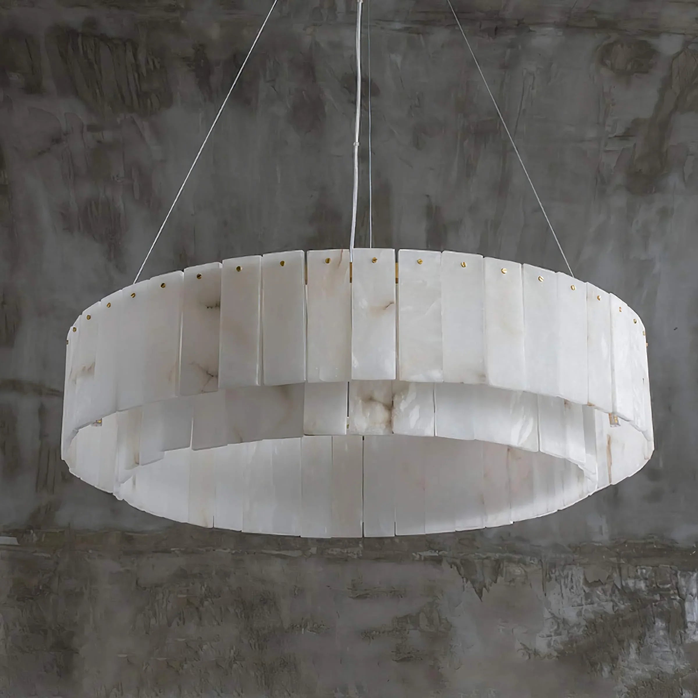 Round alabaster drum chandelier over a round dining table