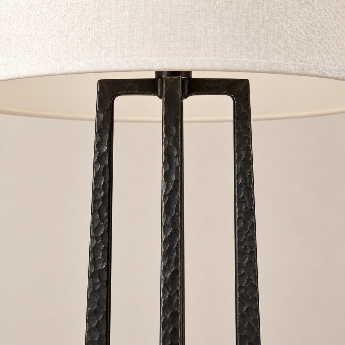 Close view of the hammered black frame and ivory fabric shade.