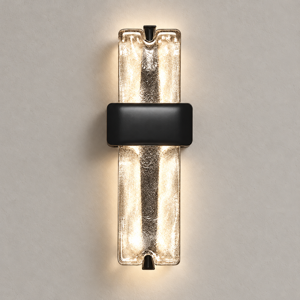 Textured glass sconce illuminated against a beige wall.