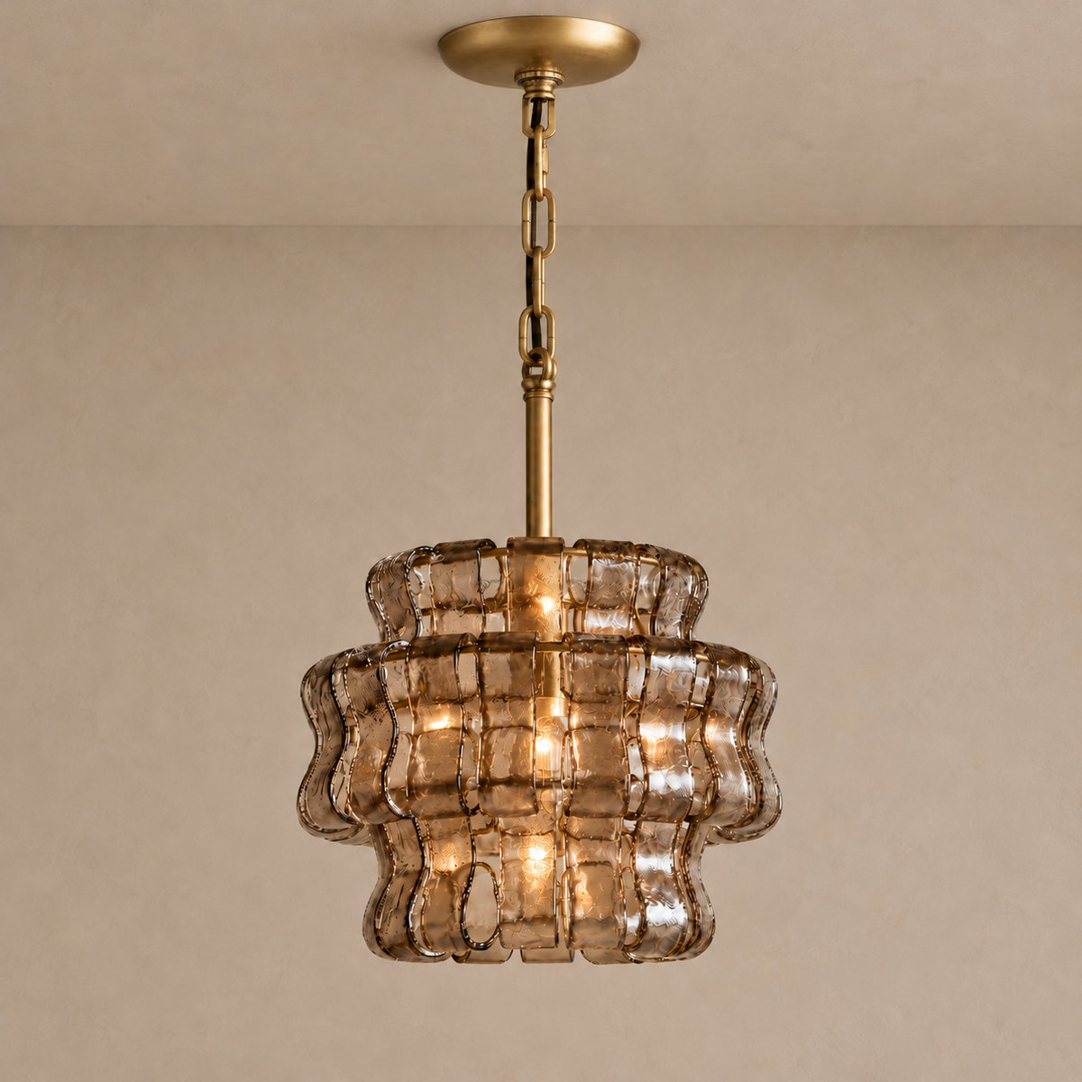 Bellatrix pendant illuminated through smoky brown curved glass, with brass suspension.