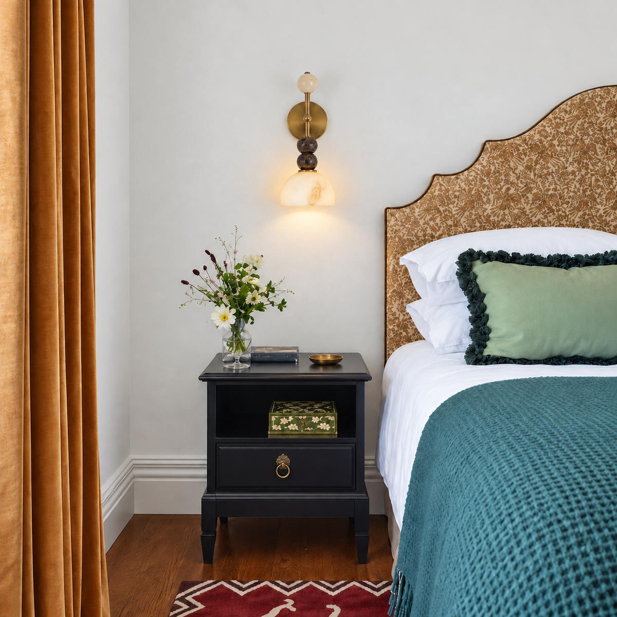 Totem Duetto alabaster and marble wall sconce beside a bed, casting a soft light onto the nightstand.