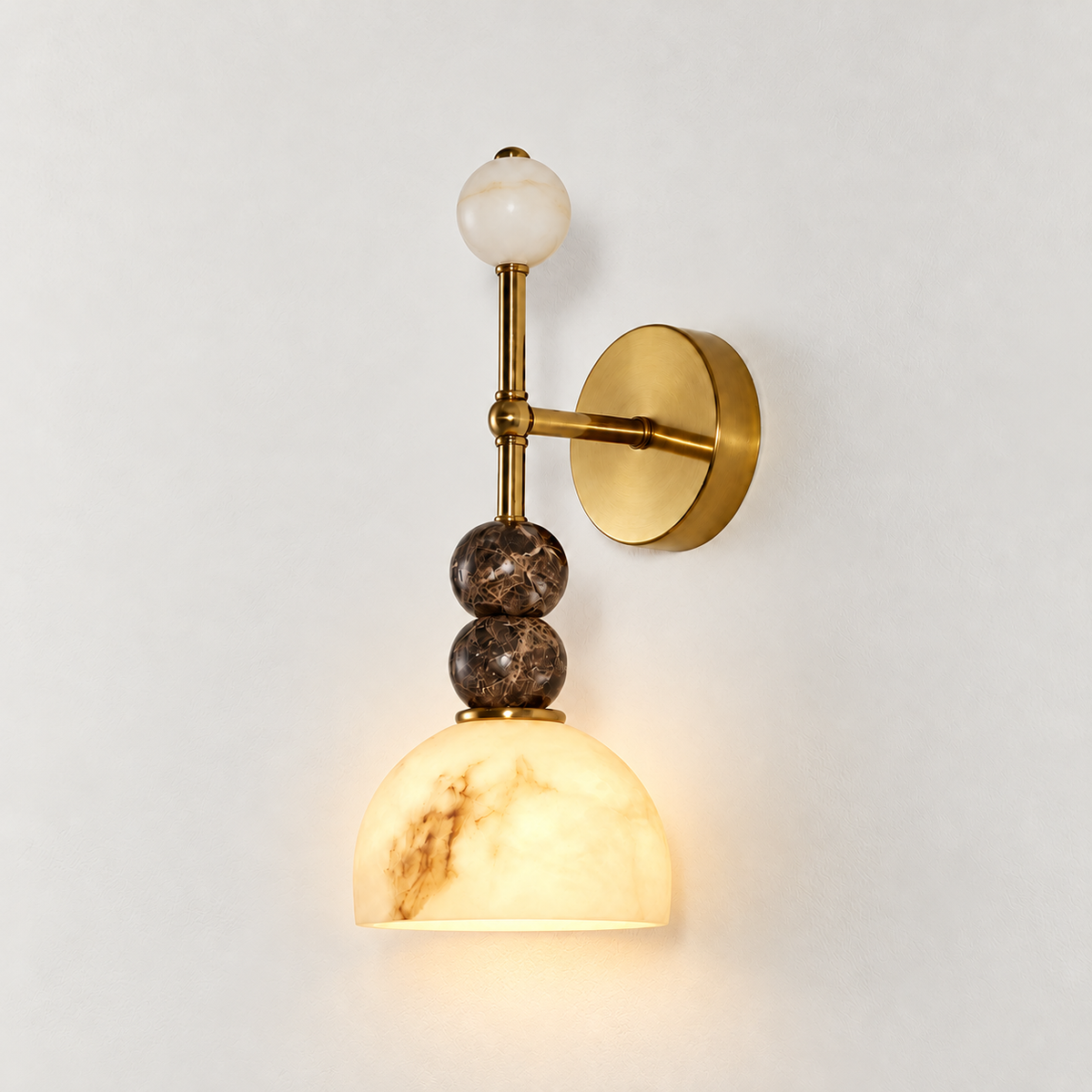 Totem Duetto wall sconce with its alabaster dome illuminated, on the same warm ivory background.