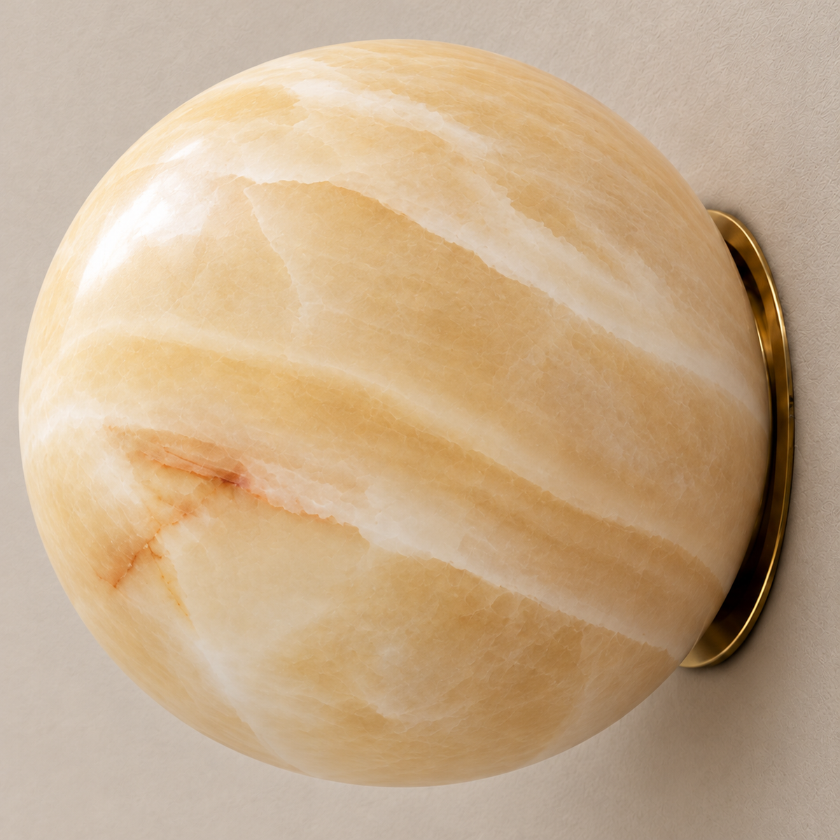 Close-up of the Totem honey onyx globe and discreet brass wall fitting.