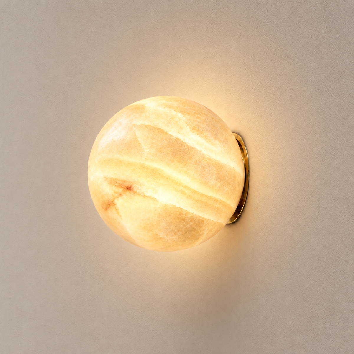 15 cm Totem honey onyx globe wall sconce with brass fitting, illuminated.