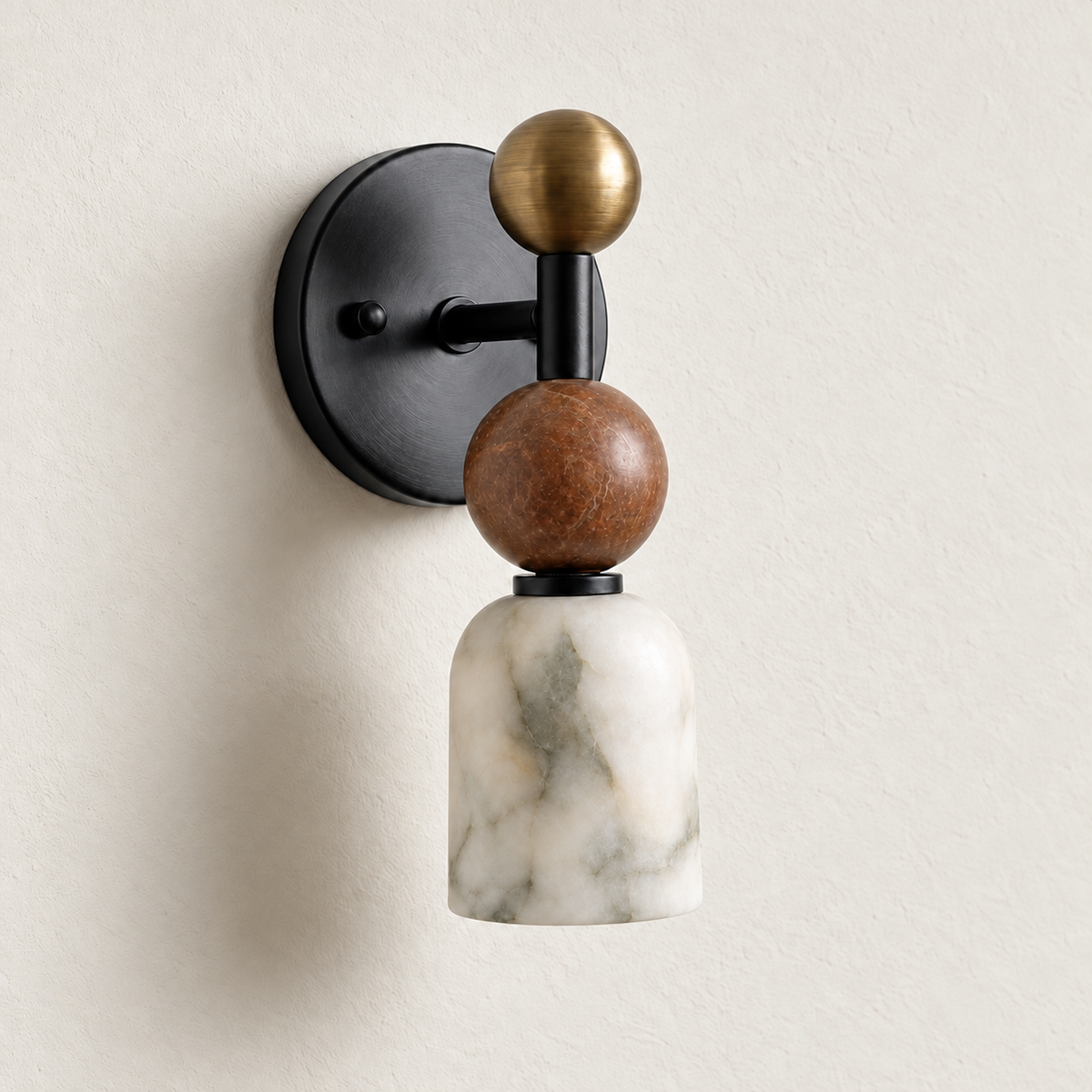 Totem Petite wall sconce in black with a Rosso marble sphere and unlit alabaster shade on warm ivory.