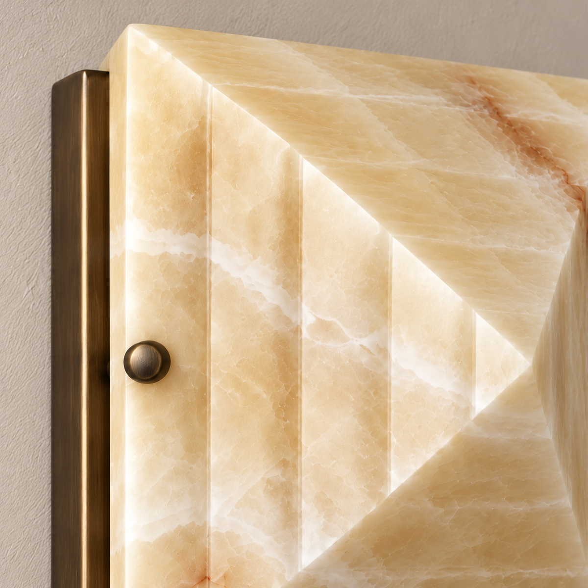 Close-up of the stepped honey onyx face, metal fastener and supporting backplate.