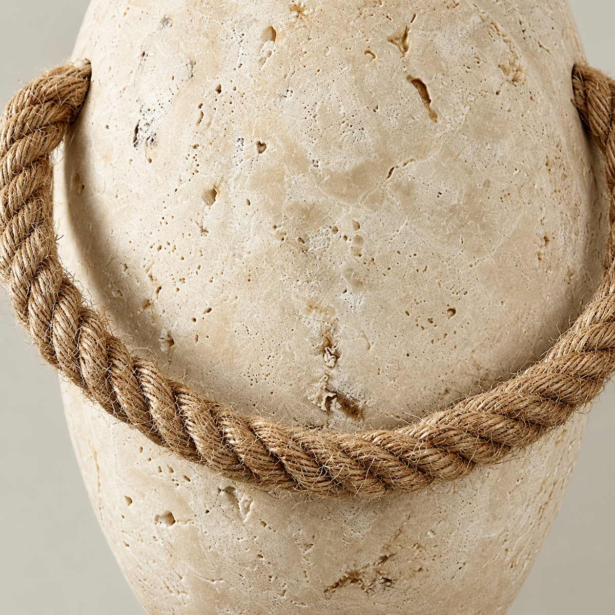 Close-up of the natural rope fibres, attachment holes and porous travertine.