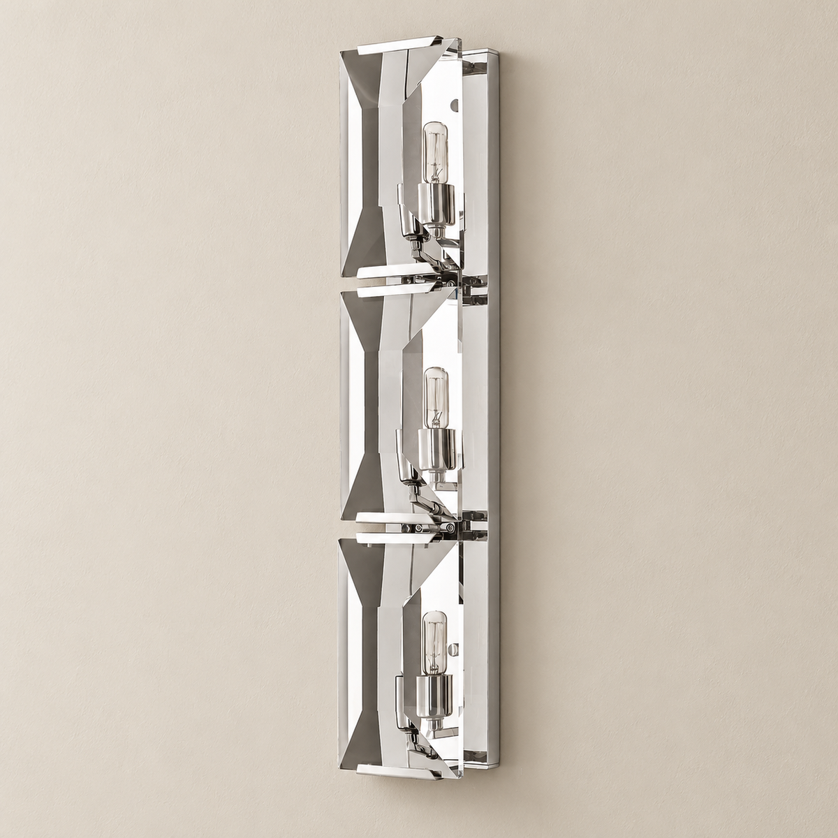 Triple crystal wall sconce with a silver finish, shown from an angle.