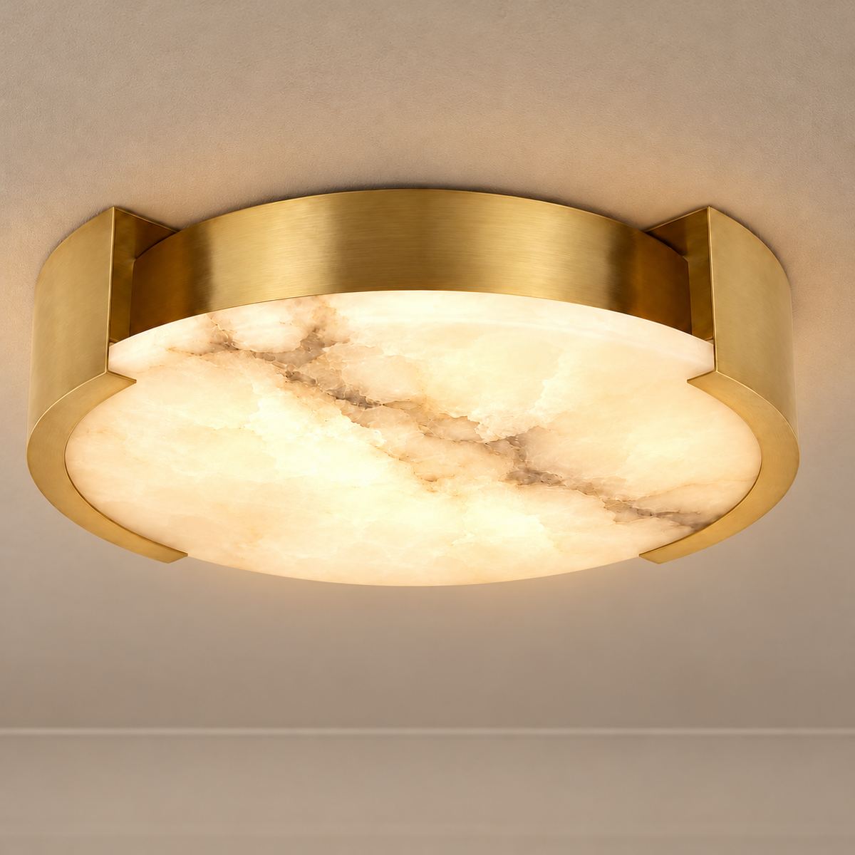 Velatura brass flush mount illuminated through natural cloudy alabaster.