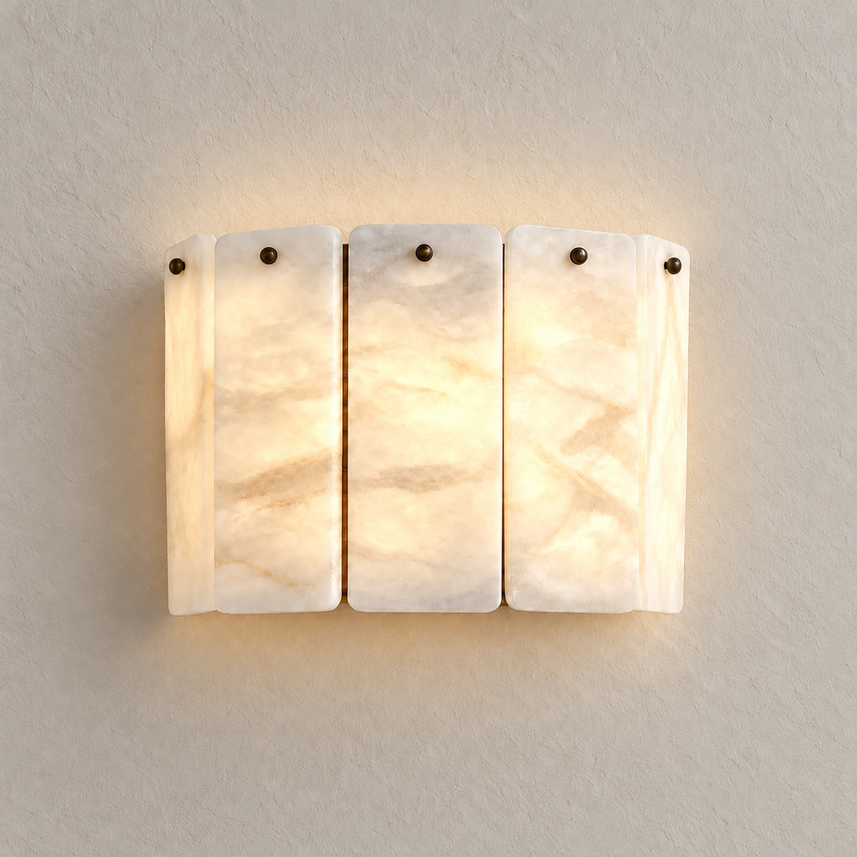 Five-panel alabaster wall sconce, illuminated on ivory plaster.
